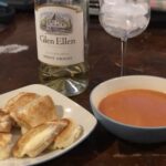 Crispy grilled cheese on toasted sourdough bread with gooey melted cheese, served alongside classic tomato soup.